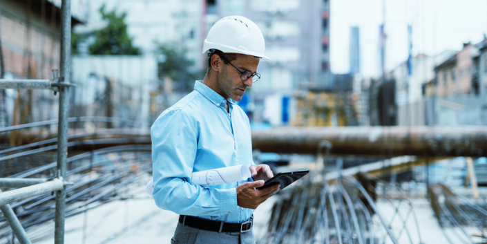FullClarity Construction for NetSuite Construction worker or engineer using digital tablet FullClarity Construction for NetSuite